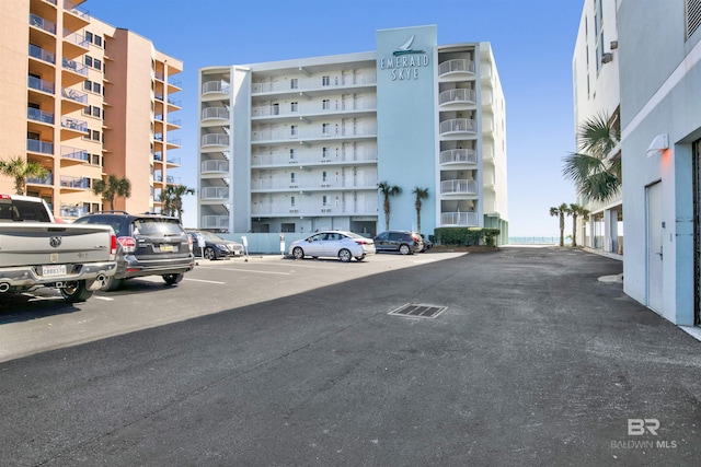 view of building exterior featuring uncovered parking