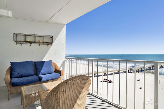 balcony with a water view and a beach view