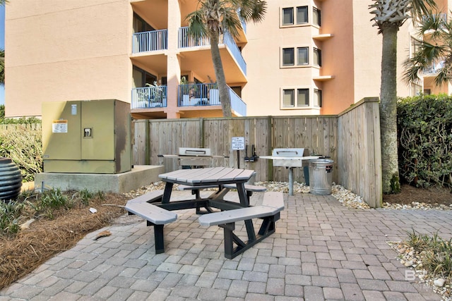 view of community featuring a patio and fence