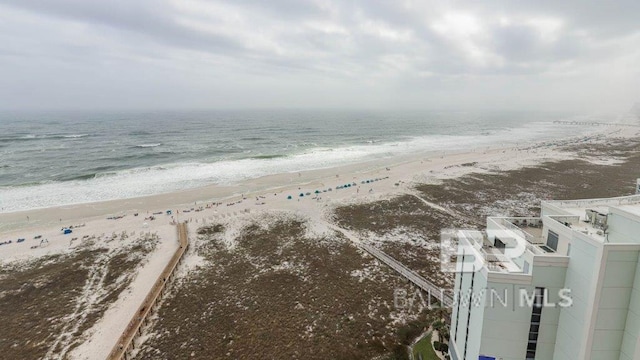 birds eye view of property with a water view and a view of the beach