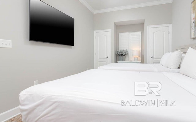 bedroom featuring baseboards and crown molding