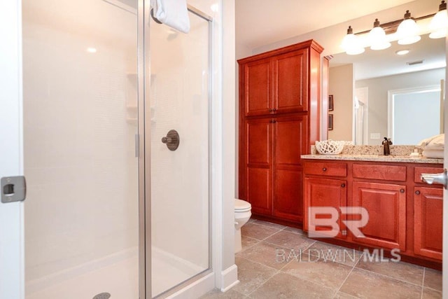 bathroom featuring visible vents, toilet, a stall shower, and vanity