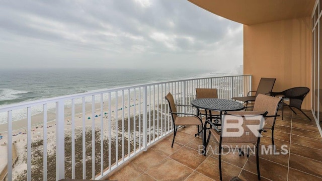 balcony featuring a water view and a view of the beach