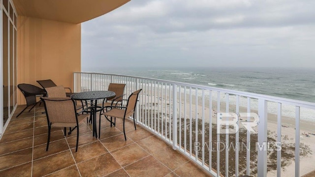 balcony with a water view and a beach view