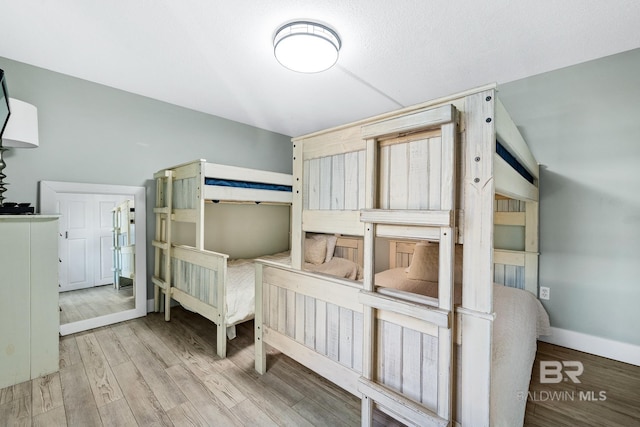 bedroom featuring light wood-style flooring and baseboards