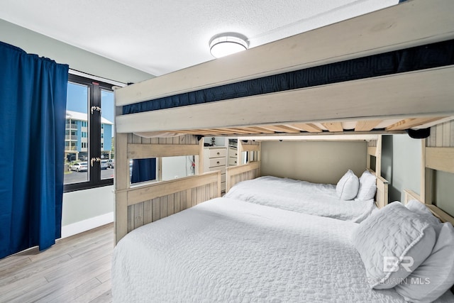 bedroom featuring baseboards and wood finished floors