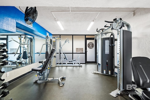 exercise room with a textured ceiling