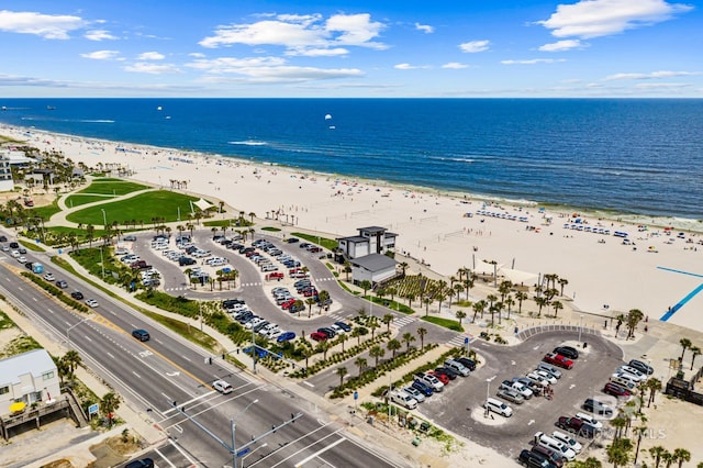 bird's eye view with a water view and a beach view