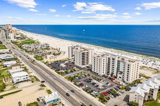 bird's eye view with a water view and a beach view