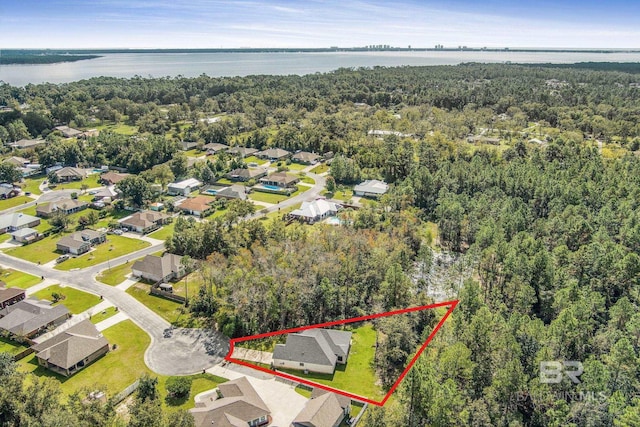 bird's eye view with a residential view, a view of trees, and a water view