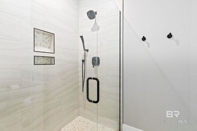 bathroom with a shower with shower door