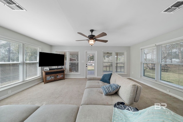 carpeted living room featuring ceiling fan