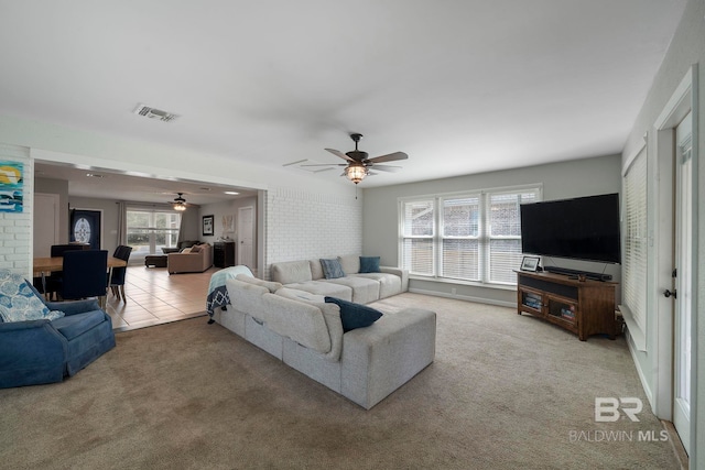 living room featuring ceiling fan and light colored carpet