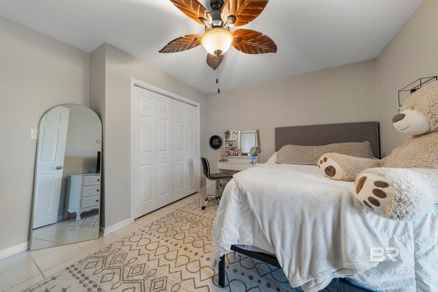 tiled bedroom featuring ceiling fan and a closet