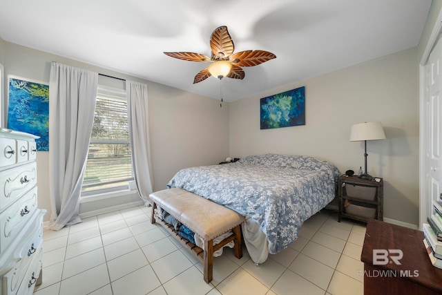 tiled bedroom featuring ceiling fan