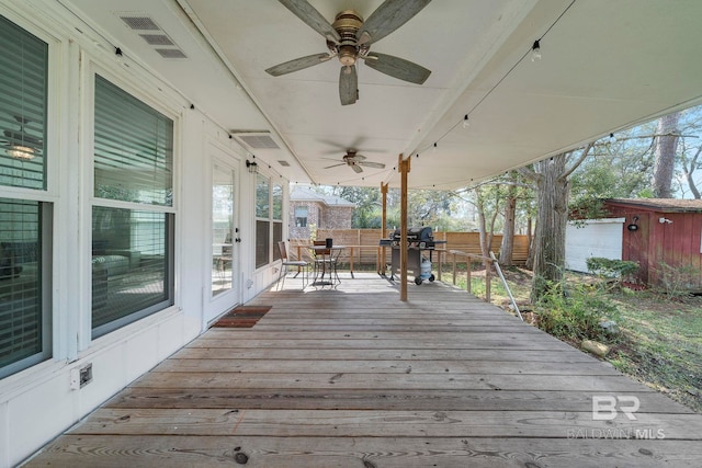 wooden deck with ceiling fan, an outdoor structure, and grilling area