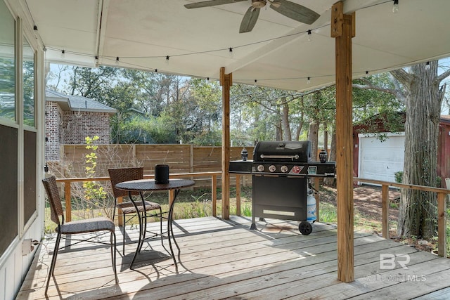 wooden deck with ceiling fan and grilling area