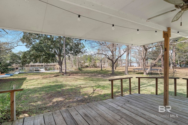 wooden terrace featuring a water view, a yard, and ceiling fan