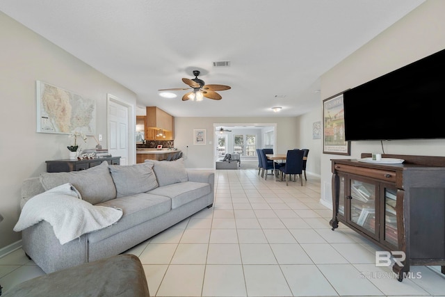 living room featuring light tile patterned floors and ceiling fan