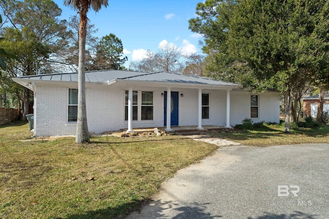 ranch-style house with covered porch and a front lawn