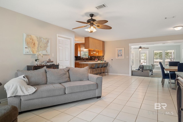 tiled living room with sink and ceiling fan