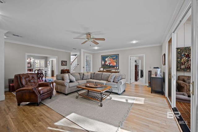 22649 Alice Ln, Fairhope, AL 36532 - living area featuring visible vents, light wood-style flooring, ornamental molding, and stairway