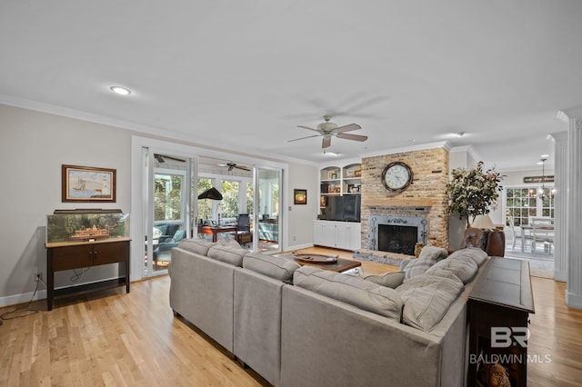 22649 Alice Ln, Fairhope, AL 36532 - living room featuring light wood-style flooring, a brick fireplace, and crown molding