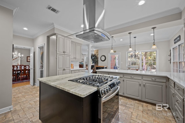 22649 Alice Ln, Fairhope, AL 36532 - kitchen with island exhaust hood, a notable chandelier, stainless steel range with gas stovetop, and gray cabinets