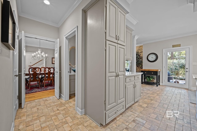 22649 Alice Ln, Fairhope, AL 36532 - interior space with brick floor, a chandelier, crown molding, and light countertops