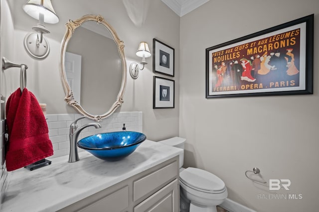 22649 Alice Ln, Fairhope, AL 36532 - bathroom featuring decorative backsplash, toilet, vanity, and ornamental molding