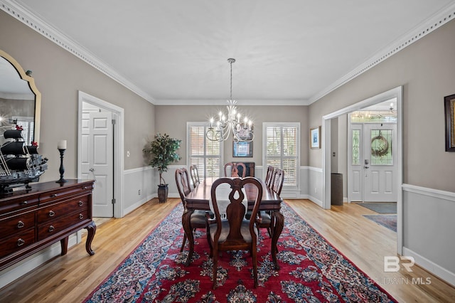 22649 Alice Ln, Fairhope, AL 36532 - dining space with light wood-style floors, an inviting chandelier, and ornamental molding