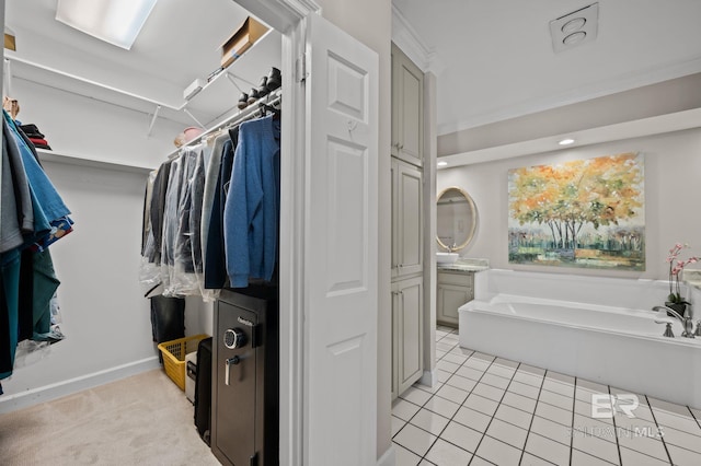 22649 Alice Ln, Fairhope, AL 36532 - walk in closet featuring light tile patterned floors and light colored carpet