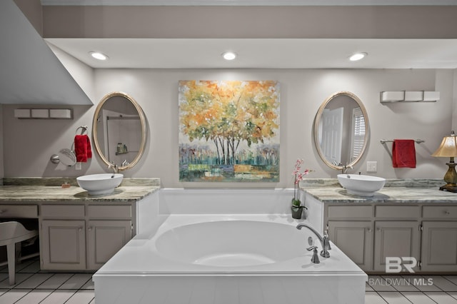 22649 Alice Ln, Fairhope, AL 36532 - bathroom with tile patterned floors, recessed lighting, a garden tub, and a sink