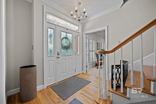 22649 Alice Ln, Fairhope, AL 36532 - entryway featuring a notable chandelier, ornamental molding, wood finished floors, stairway, and baseboards