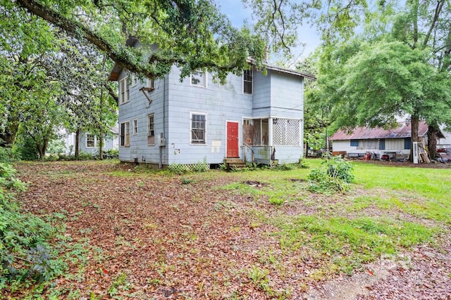 rear view of property with a yard