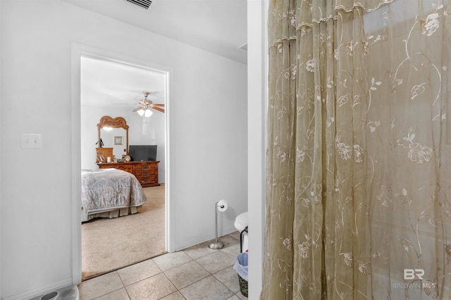 bathroom with tile patterned flooring, ceiling fan, and walk in shower