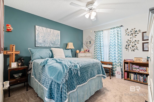 bedroom with a textured ceiling, ceiling fan, and carpet flooring