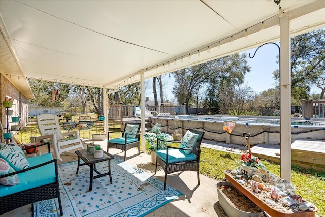 view of patio / terrace featuring an outdoor living space, a fenced backyard, and a fenced in pool