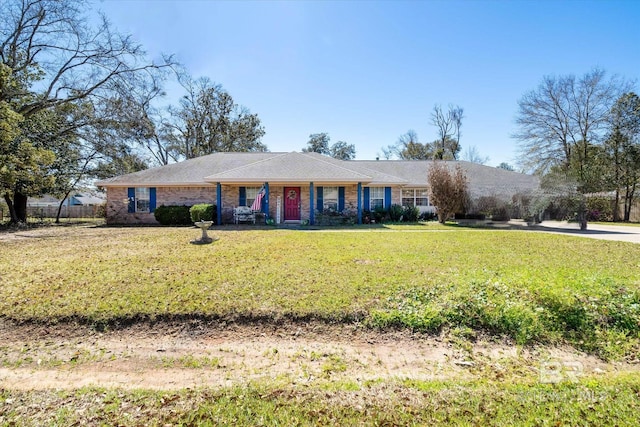 ranch-style house with a front yard and brick siding