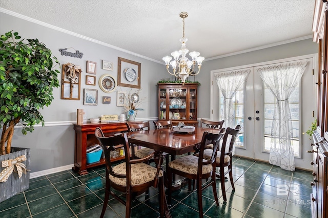 dining area featuring dark tile patterned flooring, a textured ceiling, french doors, an inviting chandelier, and crown molding