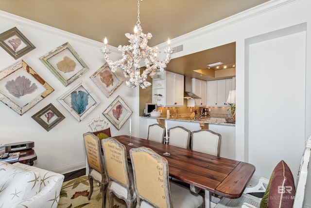 dining area with an inviting chandelier and crown molding