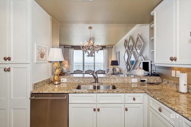 kitchen featuring stainless steel dishwasher, white cabinets, light stone counters, a notable chandelier, and sink