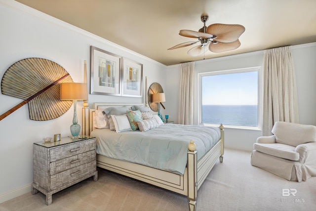 carpeted bedroom with ceiling fan, crown molding, and a water view