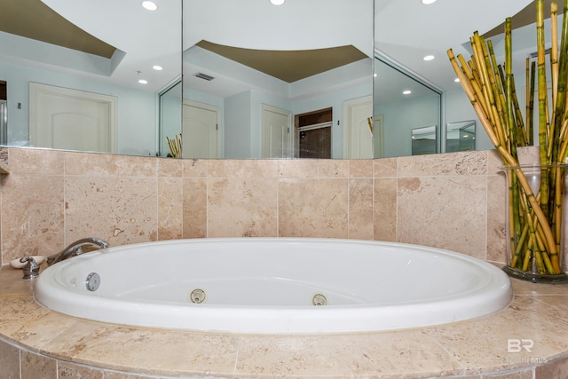 bathroom featuring tiled tub