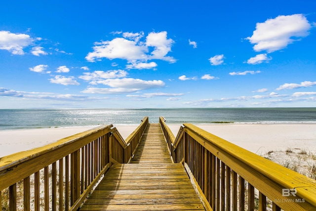 view of property's community with a beach view and a water view