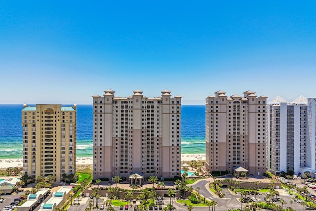 view of property with a view of the beach and a water view