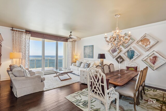 dining space featuring a water view, ornamental molding, dark hardwood / wood-style floors, and ceiling fan with notable chandelier