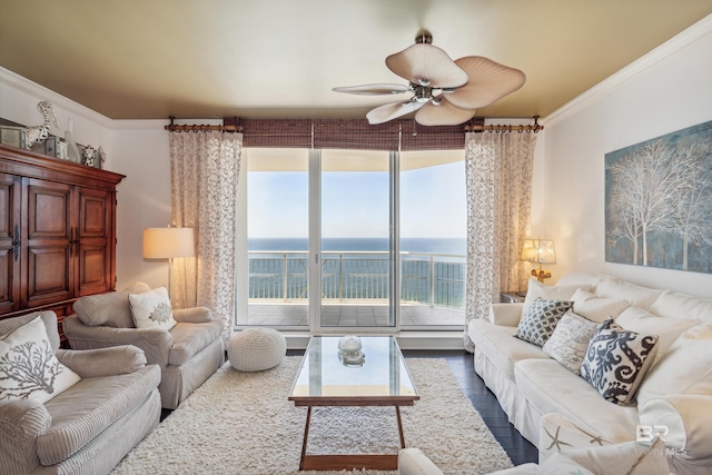 living room featuring a water view, ceiling fan, crown molding, floor to ceiling windows, and wood-type flooring