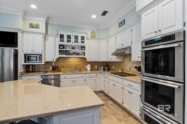 kitchen with decorative backsplash, white cabinetry, sink, and stainless steel appliances