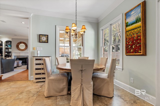 dining area with light tile patterned flooring, crown molding, and a chandelier